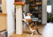 calico cat scratching tall scratching post indoors 