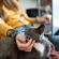 grey-and-white cat being stroked under the chin by someone with a laptop on their lap